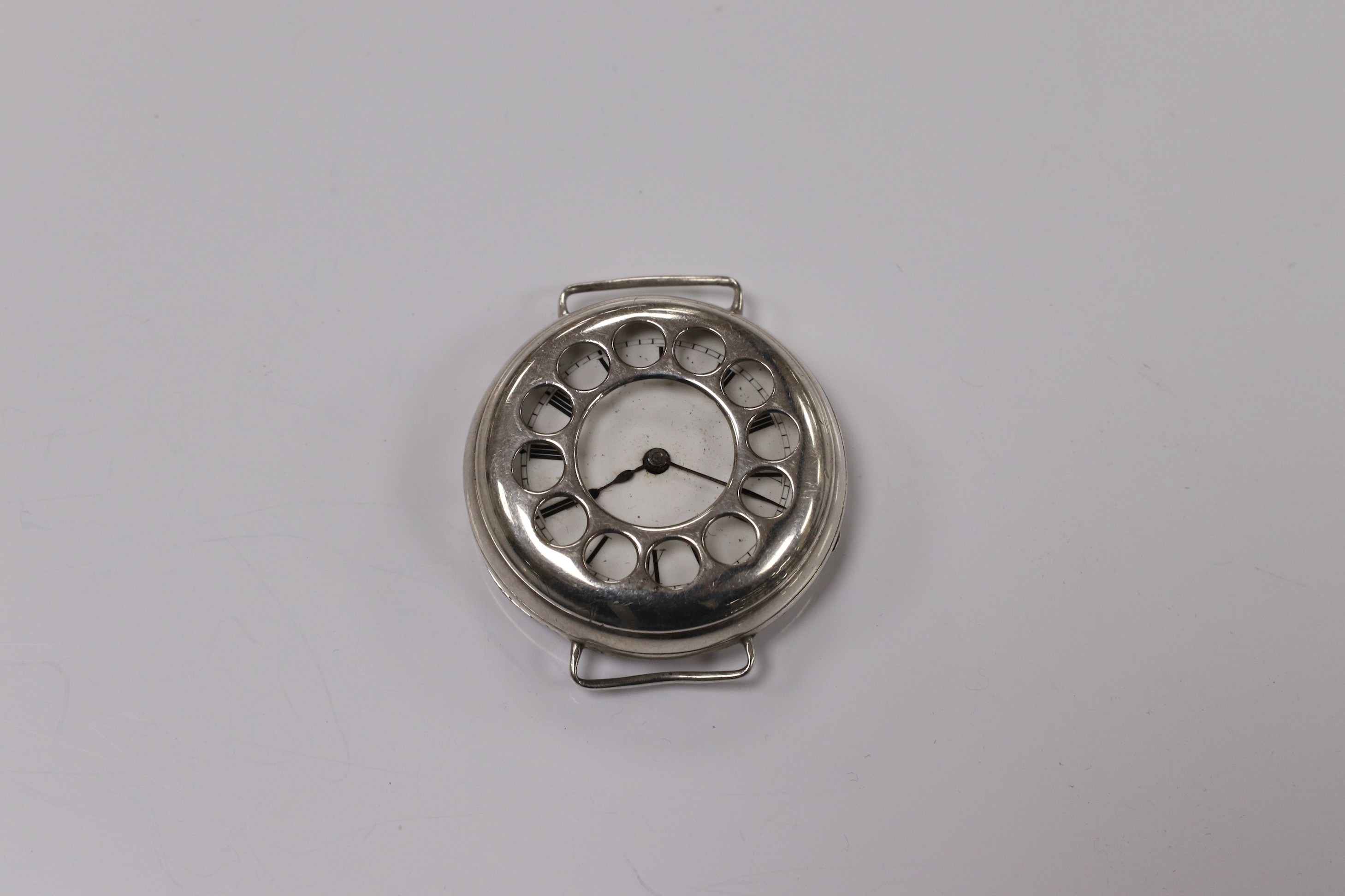 A George V silver manual wind trench watch with 'telephone dial' shrapnel guard, case import marked for London, 1917, case diameter 35mm, lacking winding crown. No strap. Condition - poor